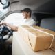 delivery driver with packages in the front seat