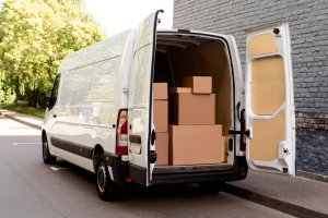 white delivery truck in line truck van to drop off shipments and packages between businesses