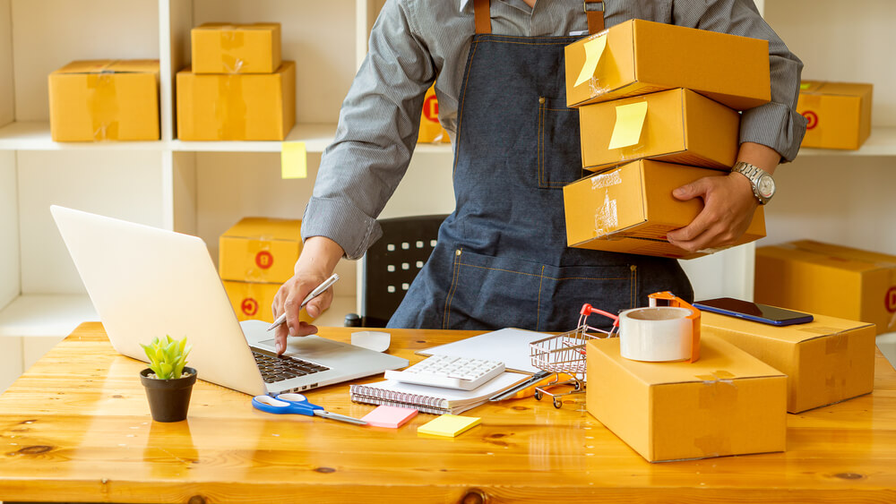 business owner shipping out products and goods using a local or national courier company for optimized delivery