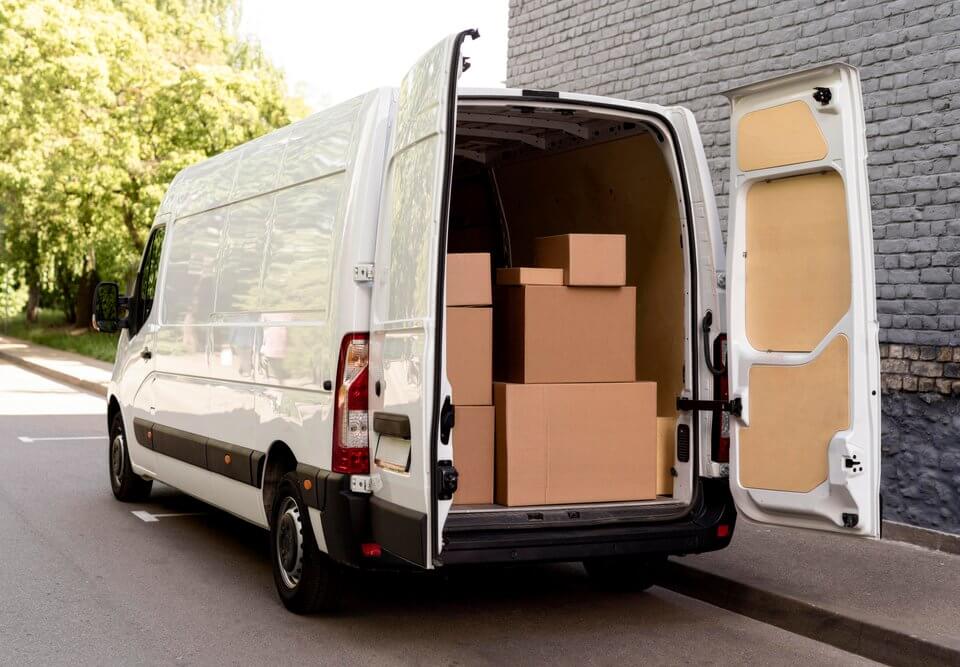 transit van courier delivery shipping vehicle preparing for cross-docking with truck for efficient shipping