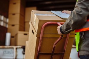 professional delivery driver courier service dropping off shipment of b2b cargo commercial deliveries based on freight class code